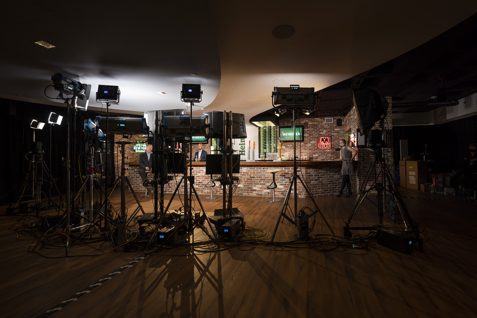 Photo behind the scenes of Lighting equipment setting the scene at a staged bar with Heineken branding