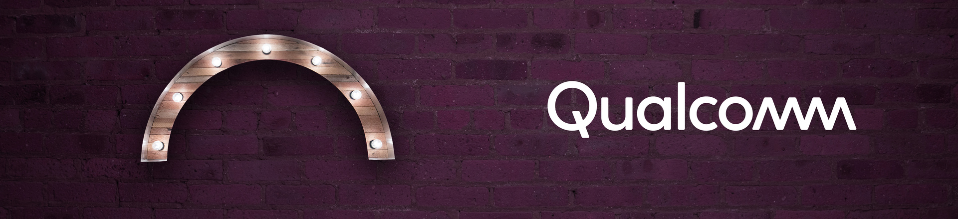 Marquee-style arch Proscenium logo and Qualcomm logo on a plum-colored brick wall background.