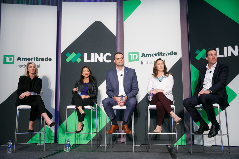 Photo of a TD Ameritrade Q&A Panel. Five Speakers are sitting on stools Center Stage in front of 4 TD Ameritrade LINC branded banners