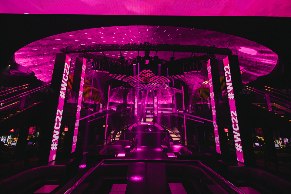 Photo of an empty LIV Night Club with magenta lighting and T-Mobile #WC22 branding.