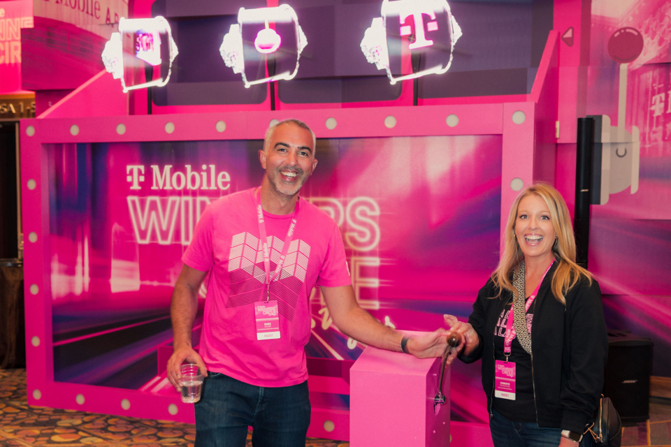 Photo of 2 guests playing an experiential game with T-Mobile Winners Circle branding